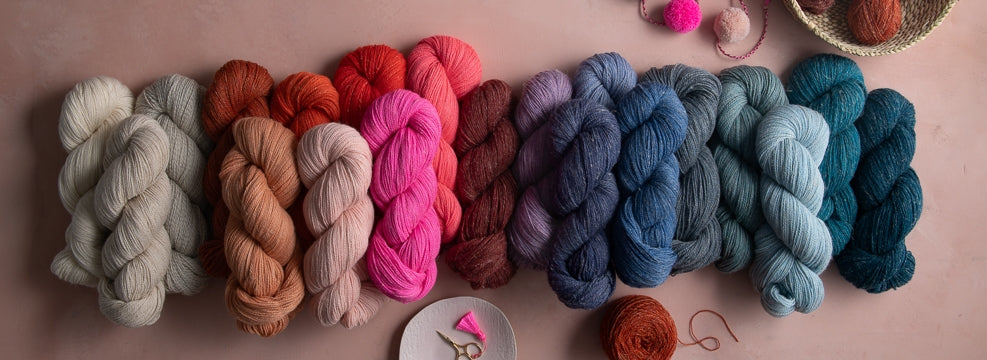 Skeins of Linen Quill, highland wool, alpaca, and linen fingering-weight yarn, shown in many colors.