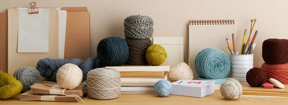 Skeins and balls of Daily Wool Sport, machine-washable superwash wool yarn in a versatile sport weight.