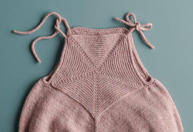 Ainur Berkimbay for Purl Soho: Pinwheel Baby Romper in Stormy Superwash Sock