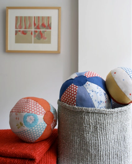 Image of DIY scrap fabric "beach balls" in a woven hamper