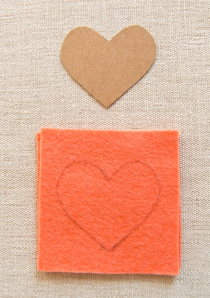 Red Paper Heart And Multicolored Sewing Pins On Gray Cement