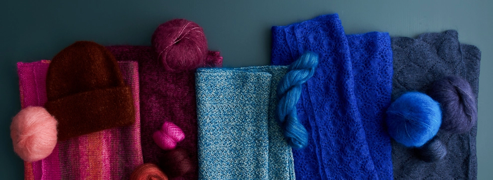 Projects knit with mohair yarn held single, held double, and held with other yarns, as well as skeins of mohair-silk Tussock and mohair-cotton Paintbrush Mohair yarns.